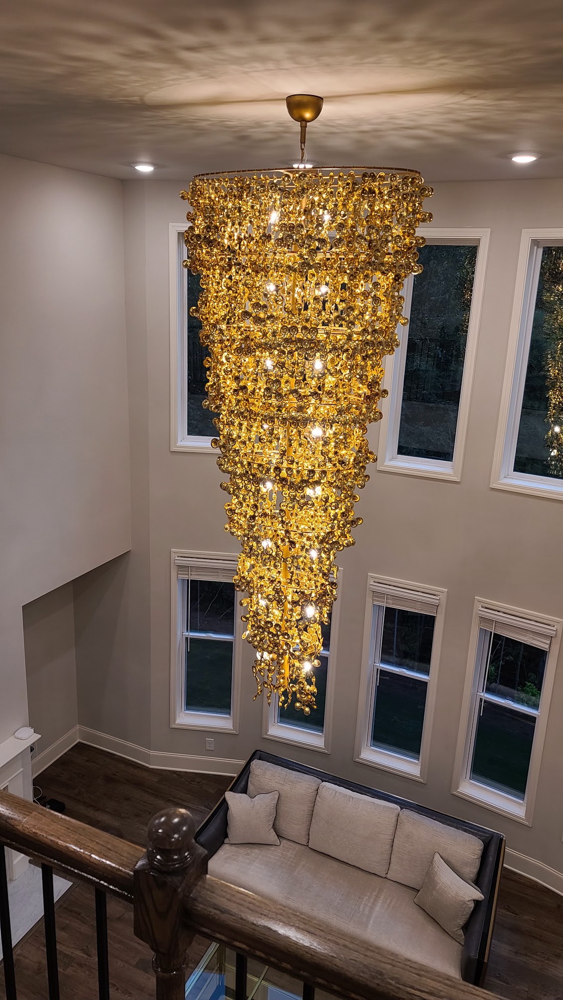 Gold spiral chandelier installed in a tall Atlanta room