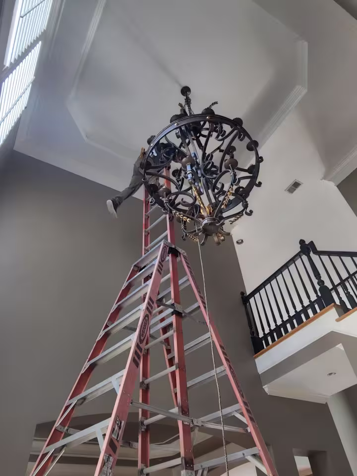 Large foyer chandelier installation in Atlanta