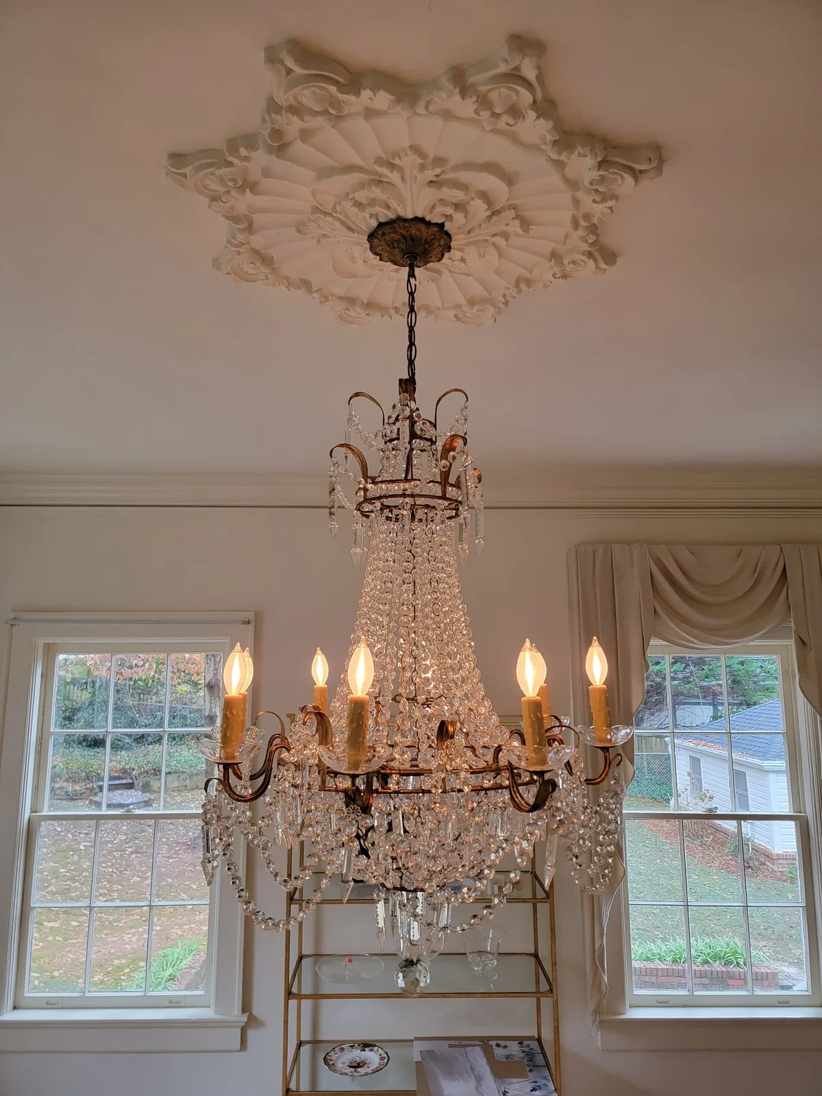 Decorative ceiling medallion installed above a chandelier in an Atlanta home