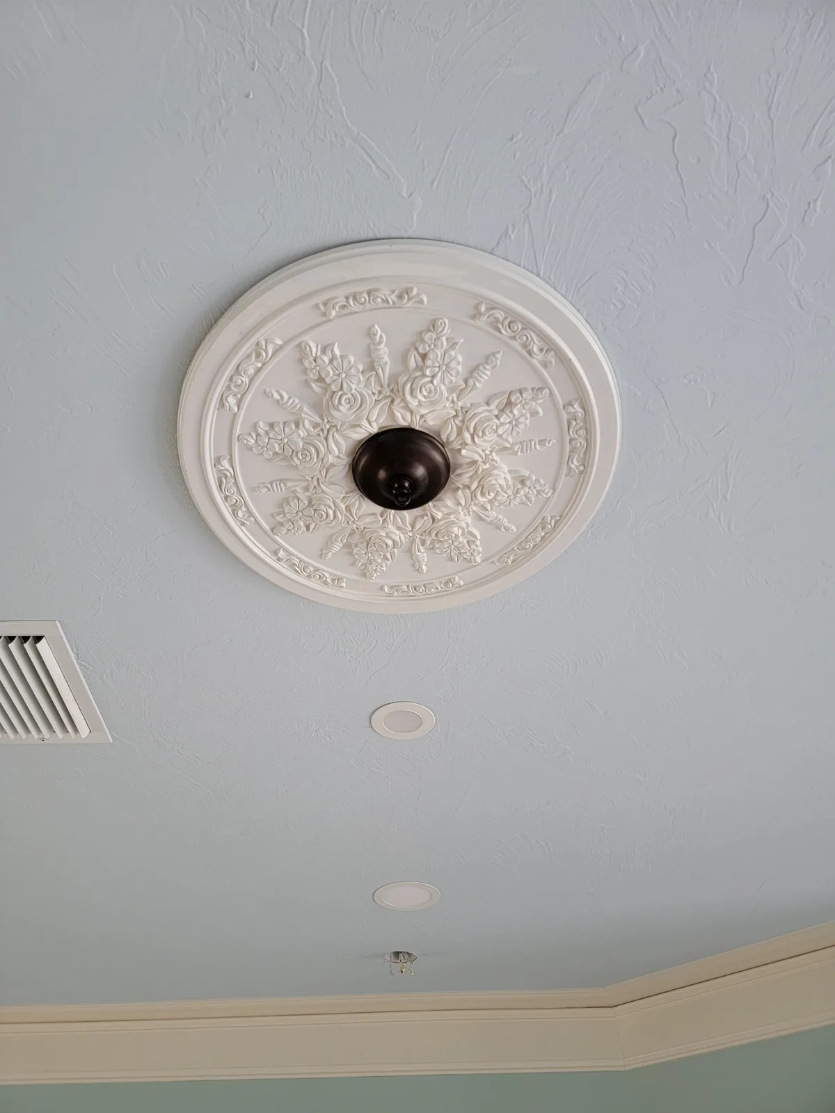 Decorative ceiling medallion installed for a chandelier in an Atlanta residence