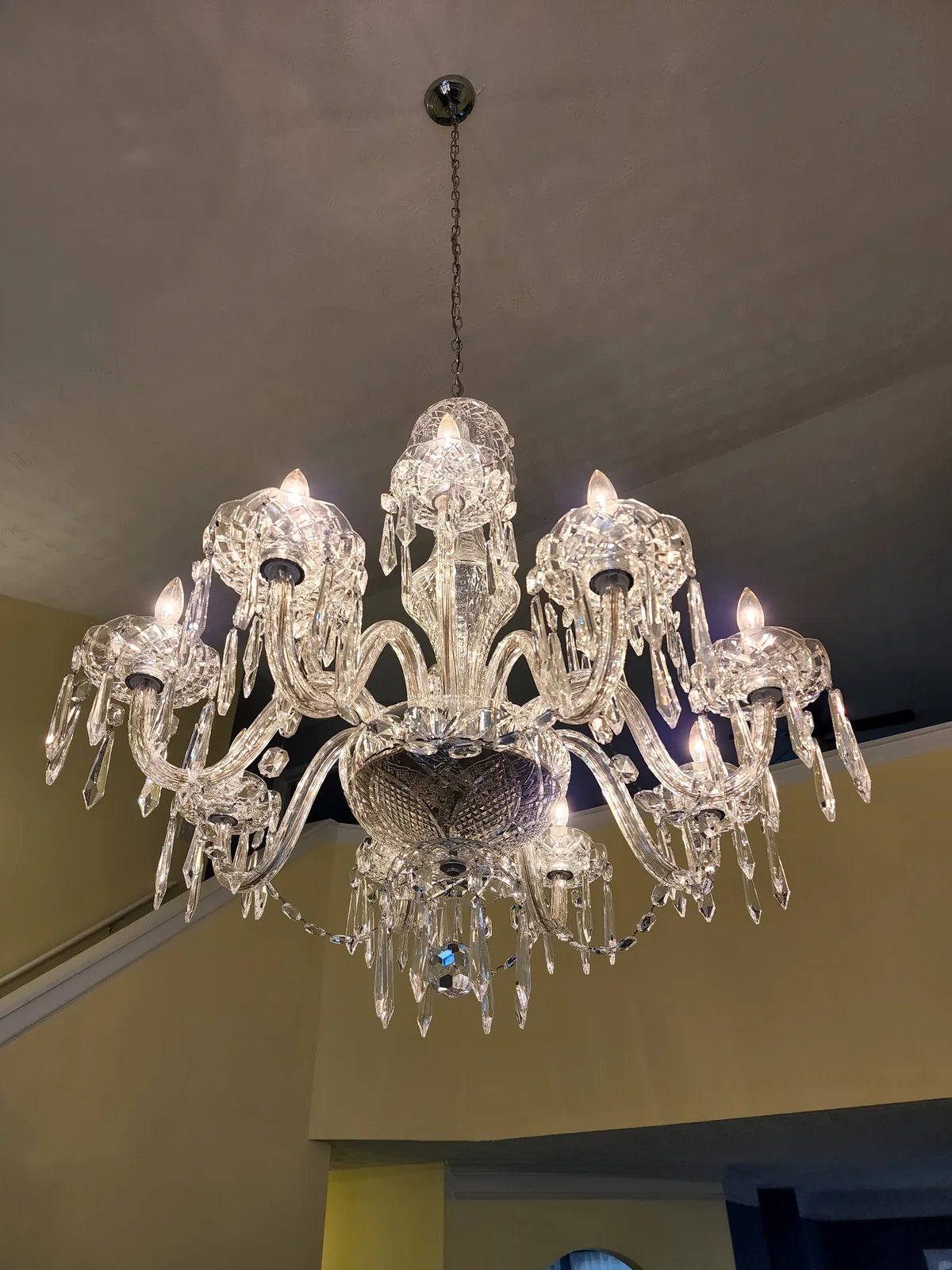 Large formal crystal chandelier installed in an Atlanta home