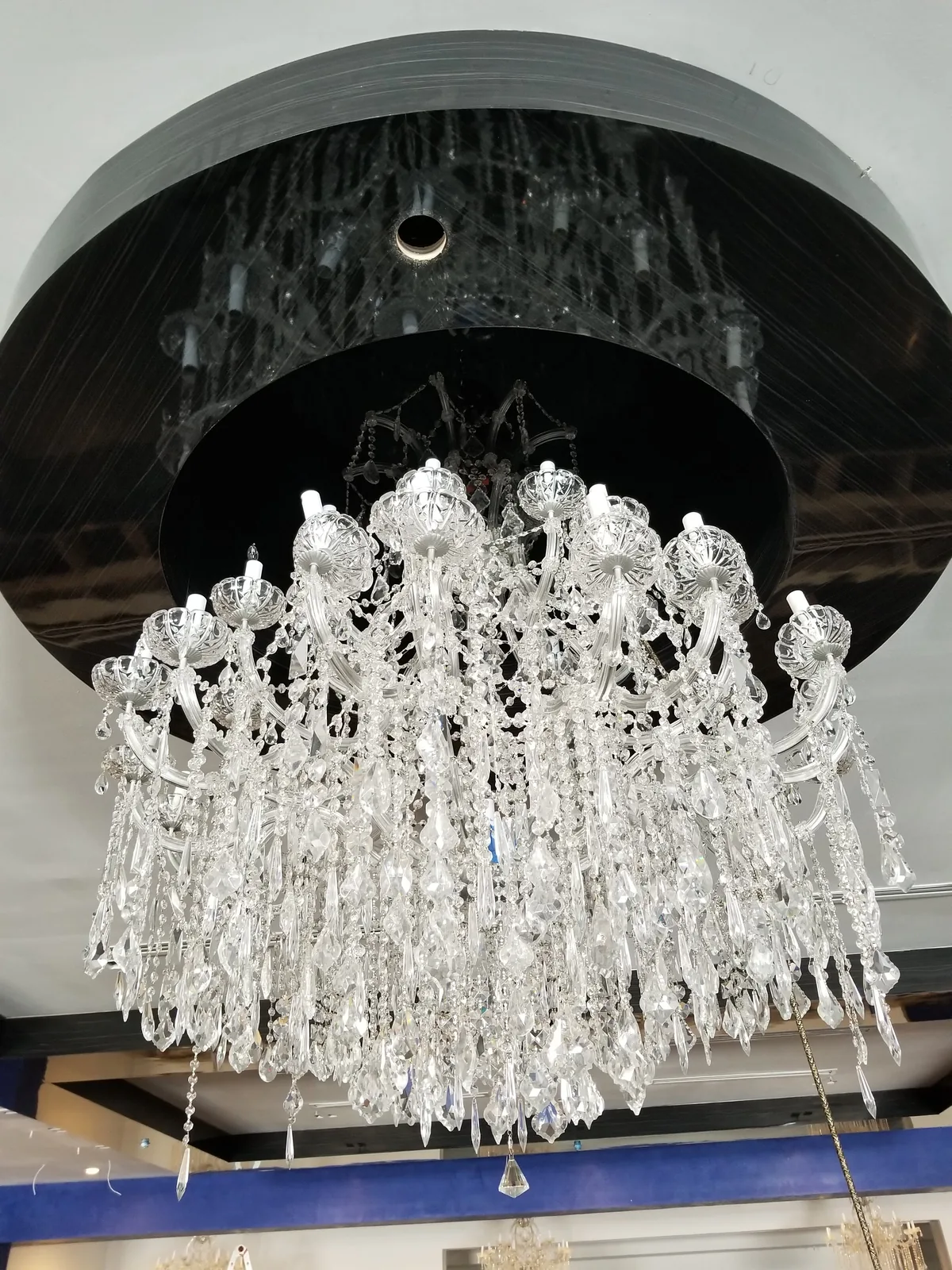 Large tiered crystal chandelier installed in an Atlanta home