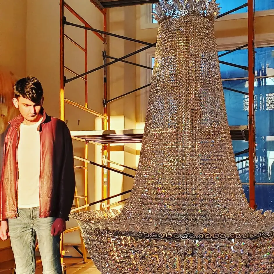Oversized Schonbek crystal chandelier installed using a chandelier lift in Atlanta