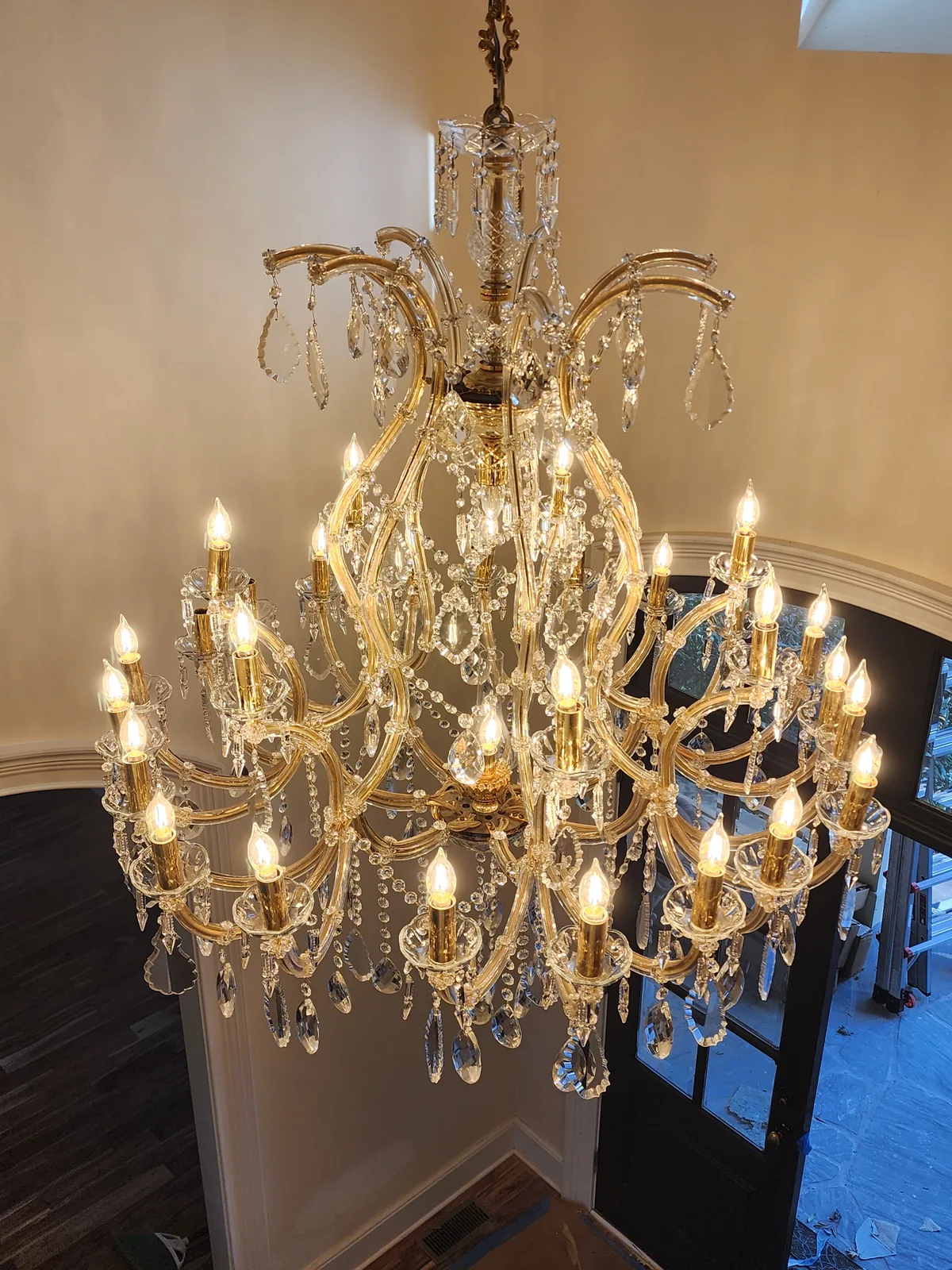 Entryway chandelier installation detail in an Atlanta home