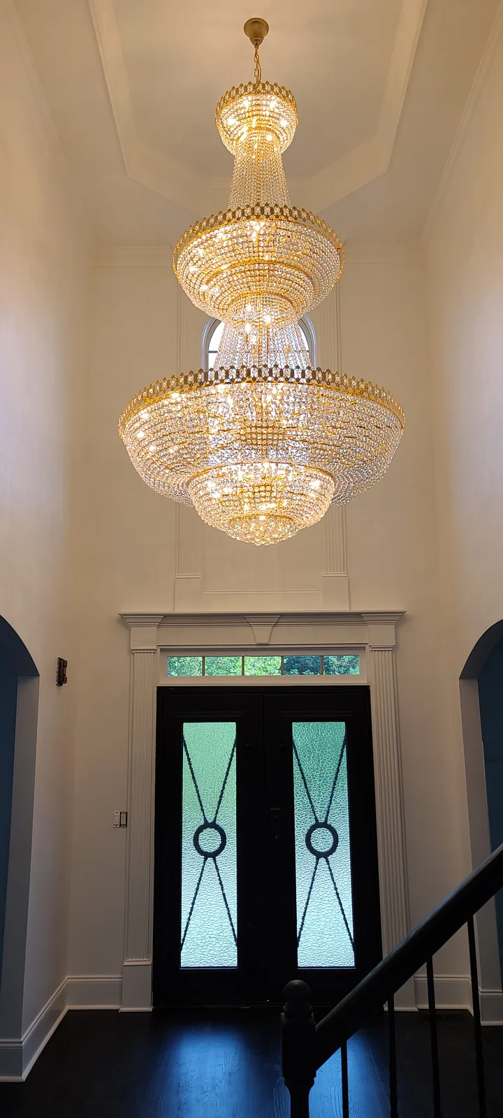 Large crystal chandelier installed in an Atlanta entryway