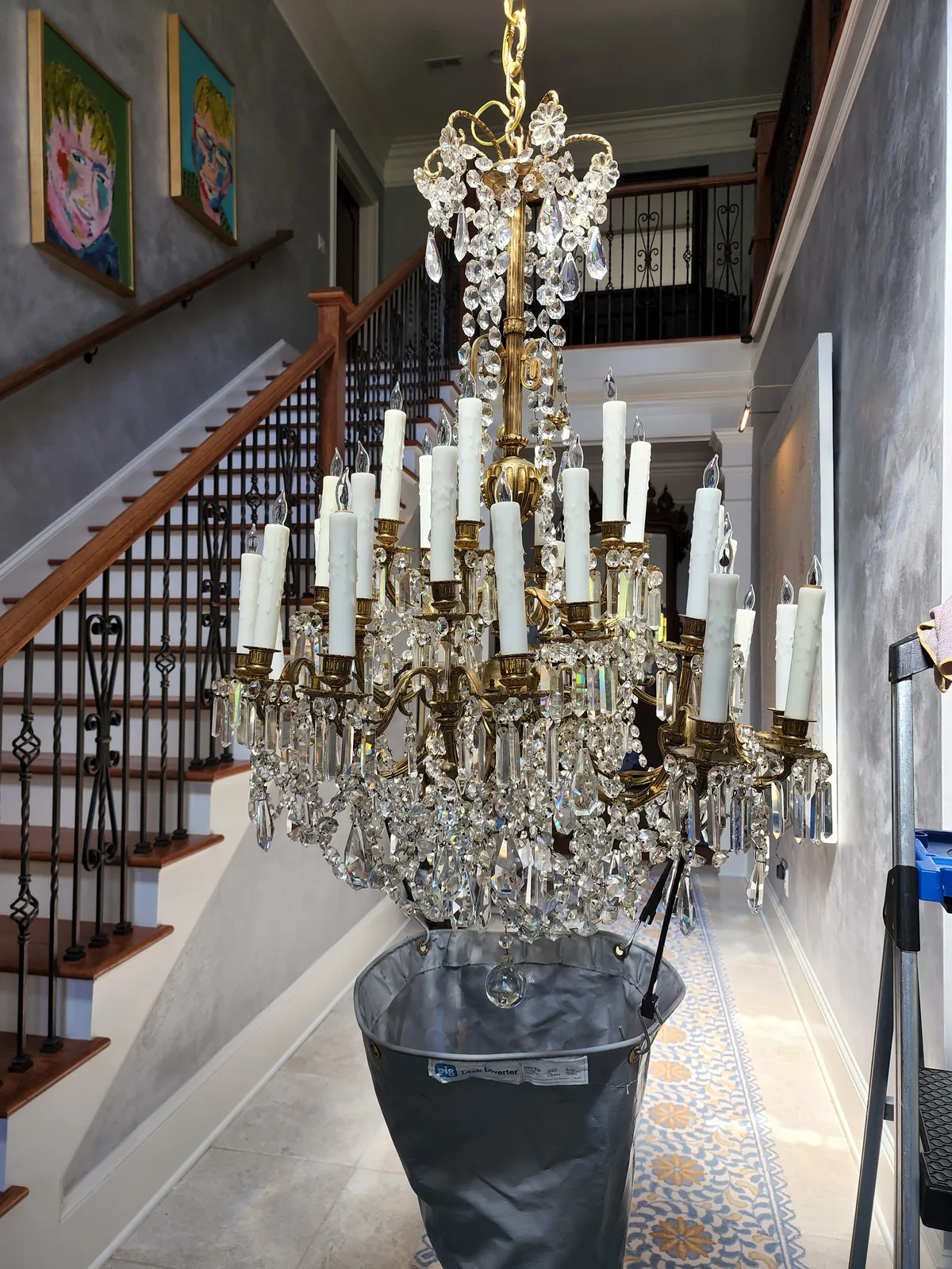 Traditional crystal chandelier installed near a staircase entry in an Atlanta home