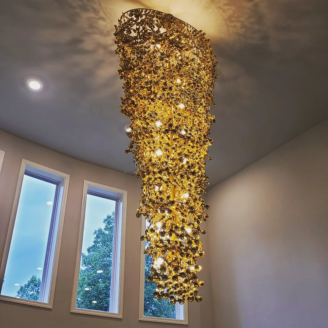 Modern gold spiral chandelier installed in an Atlanta home