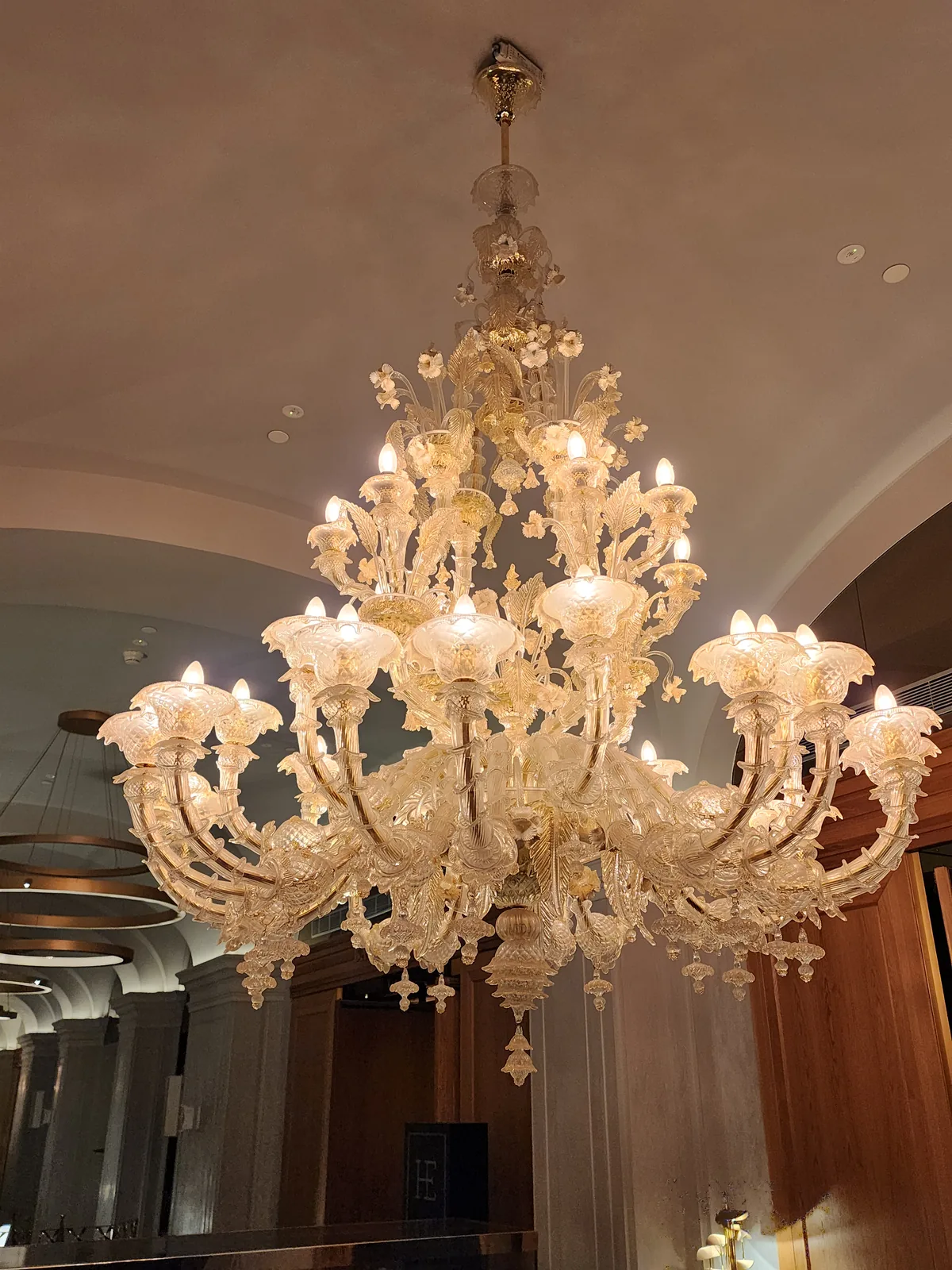 Murano-style glass chandelier installed in a high-ceiling Atlanta interior