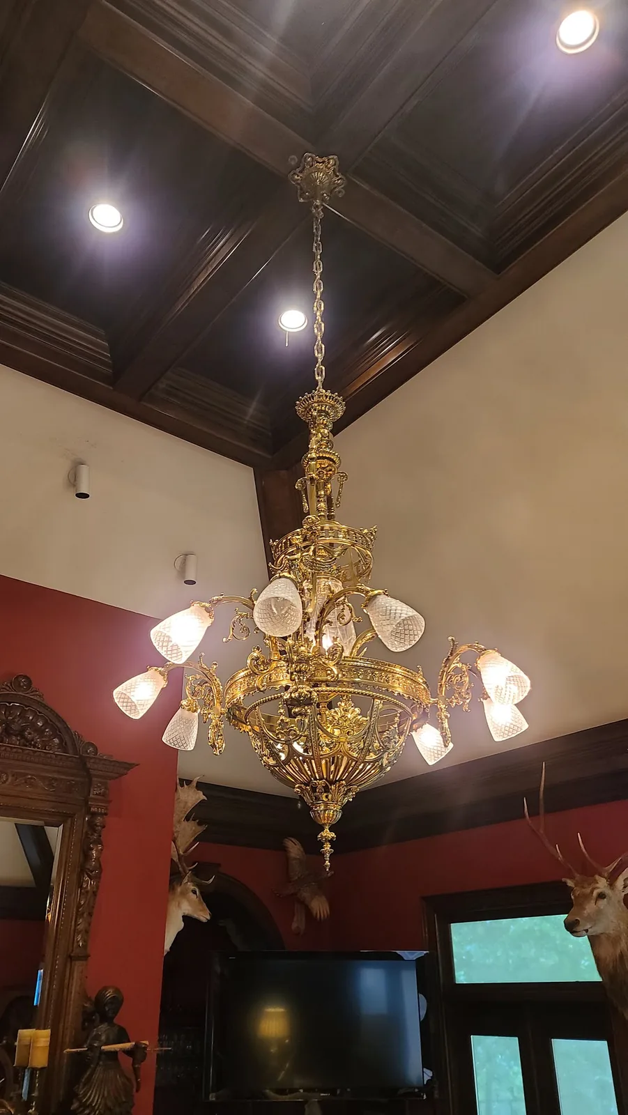 Antique brass chandelier with glass globes installed in an Atlanta home