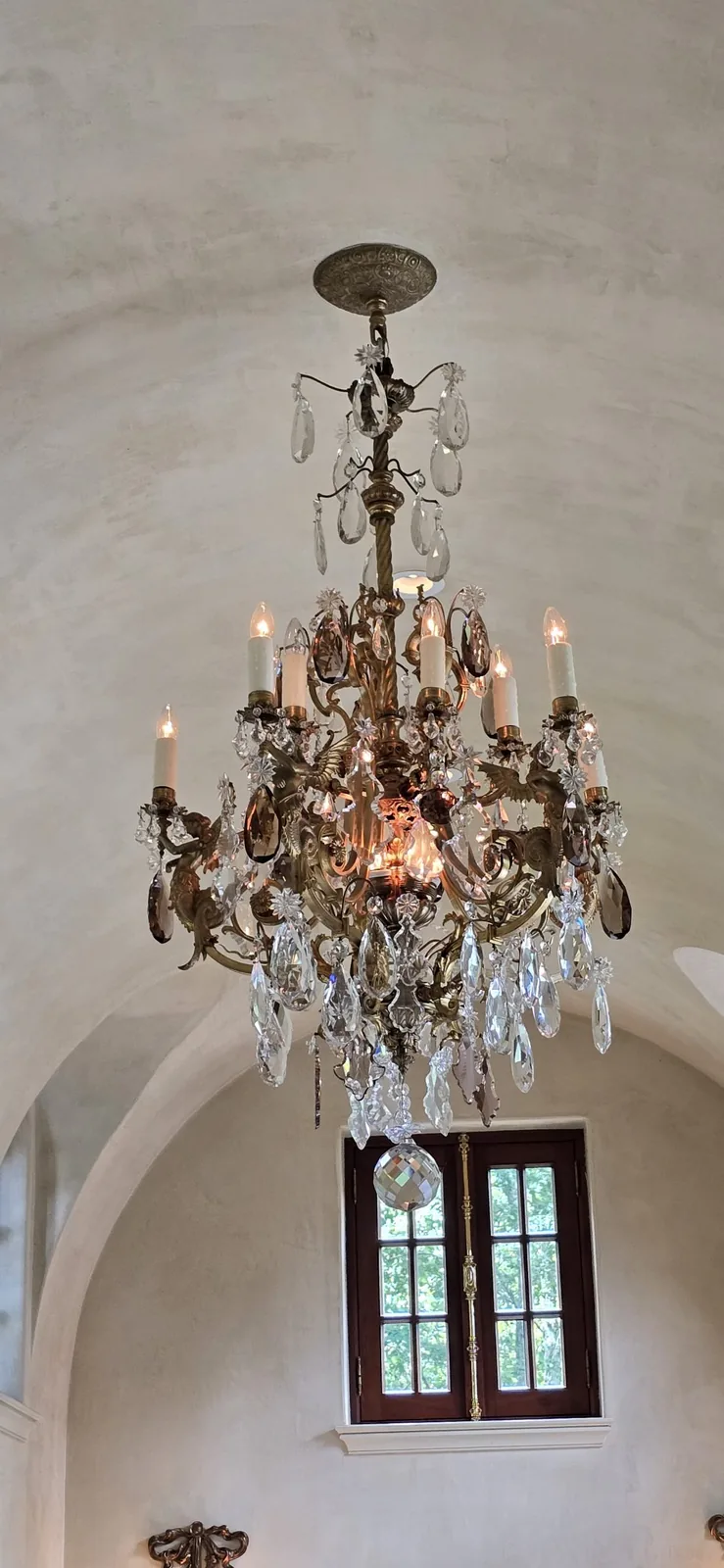 Brass and crystal chandelier installed in an Atlanta home