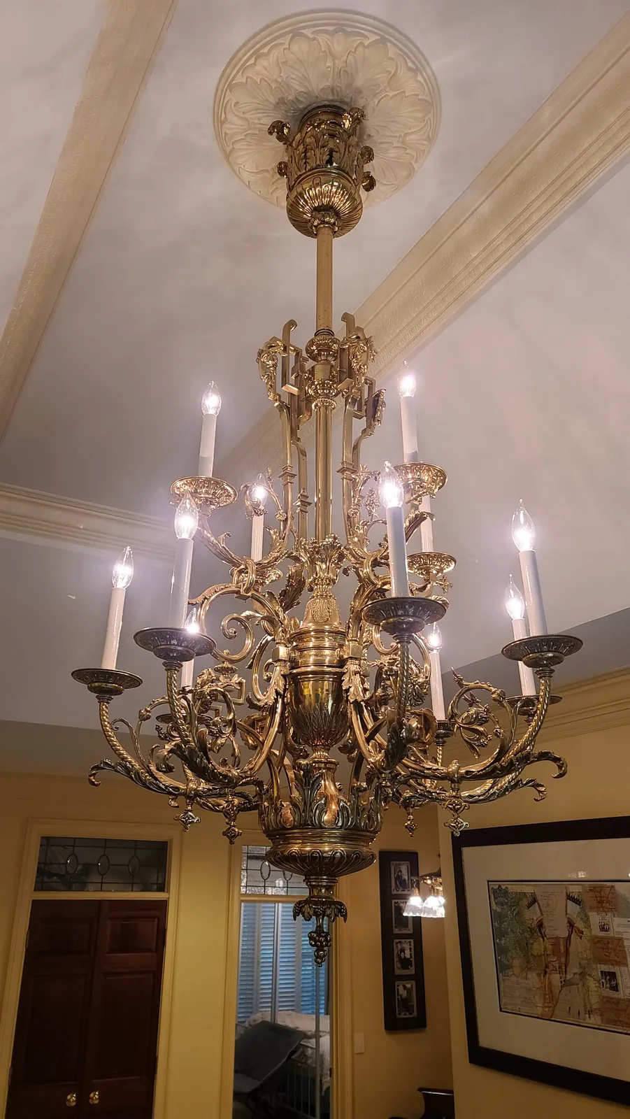 Large antique brass chandelier installed in an Atlanta home