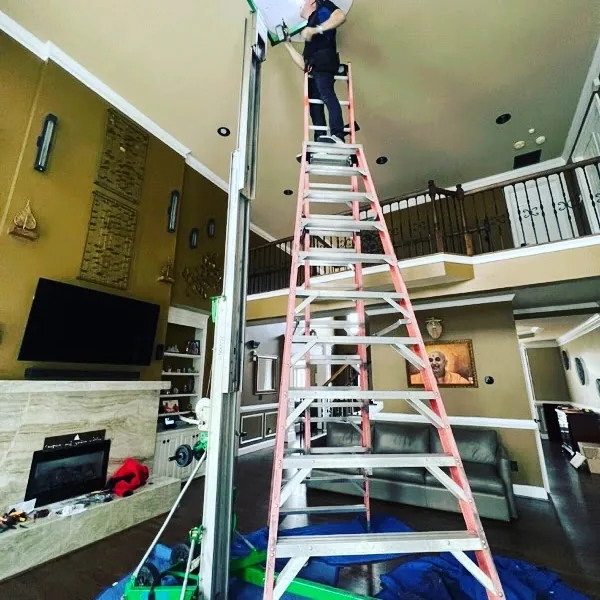Chandelier prepared for removal and transport in an Atlanta home