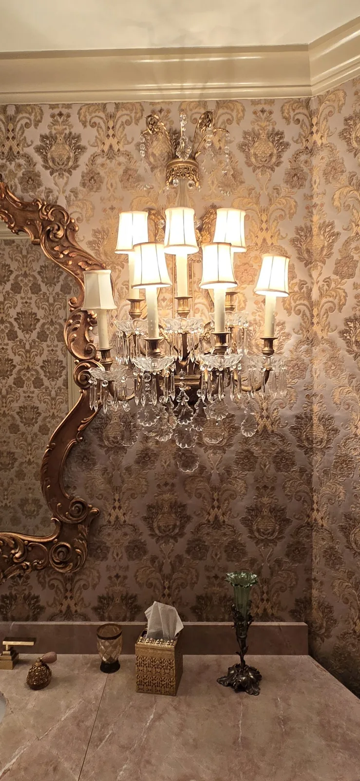 Oversized brass and crystal wall sconces installed in an Atlanta home
