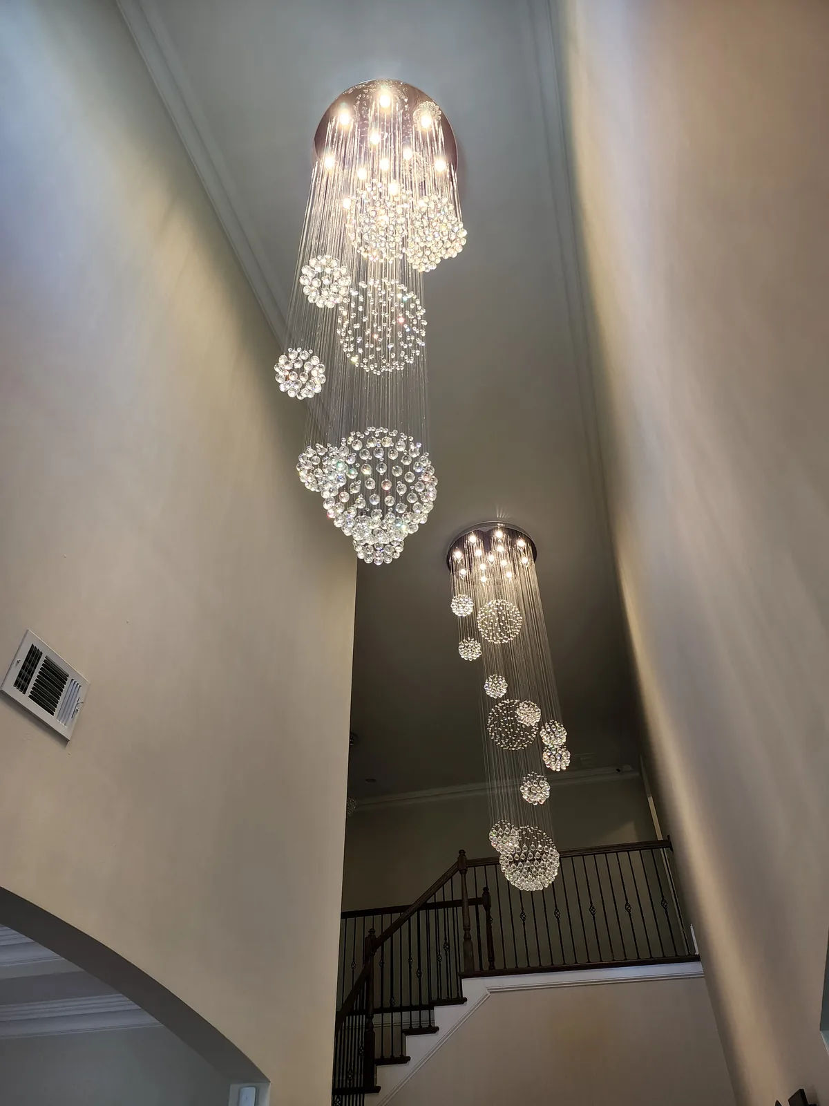 Large modern suspension chandelier installed in an Atlanta home