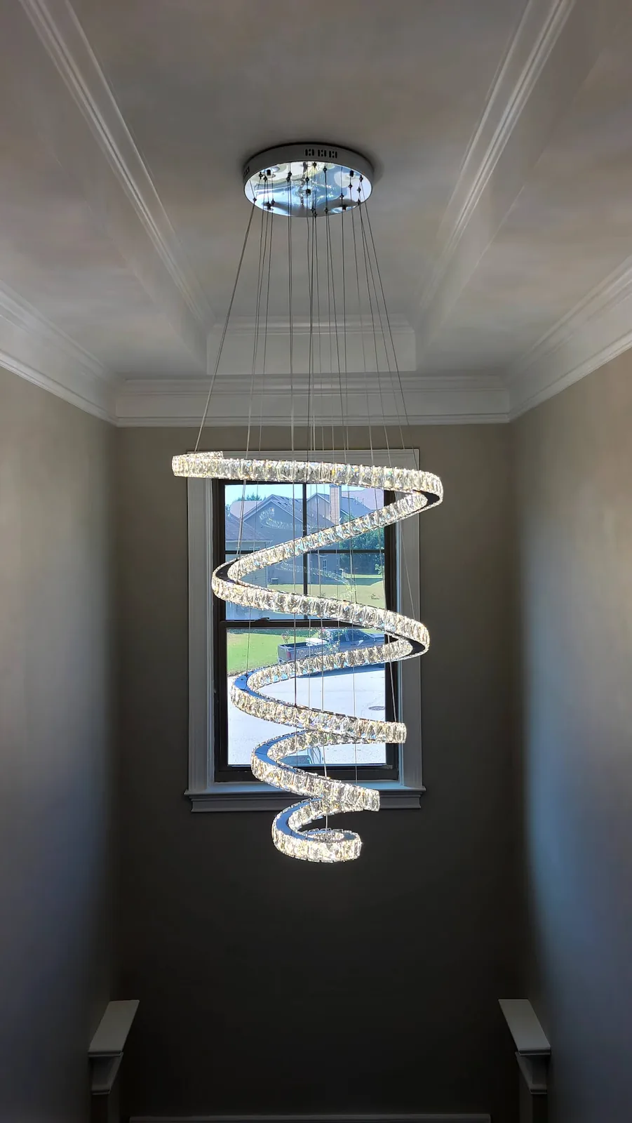 Modern crystal sphere suspension chandelier installed in a tall Atlanta interior