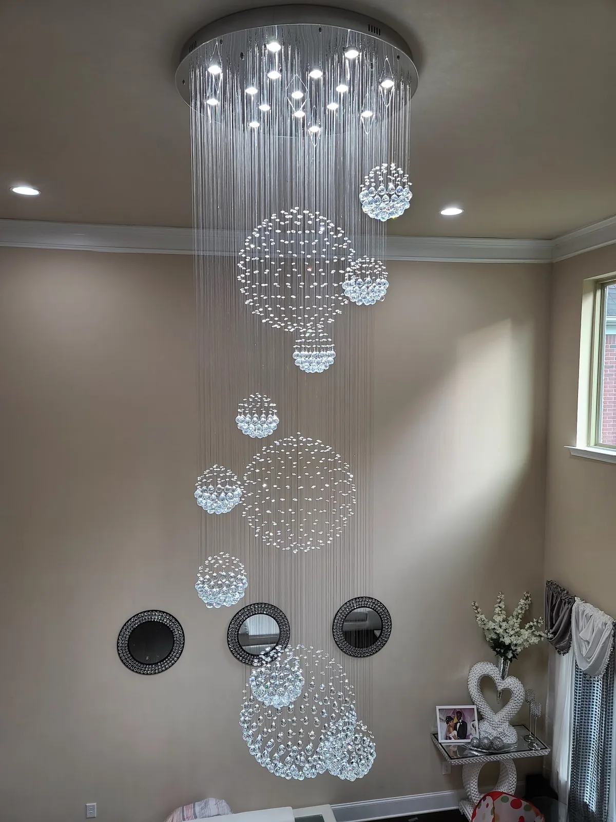 Multi-drop crystal suspension chandelier installed in a high-ceiling Atlanta room