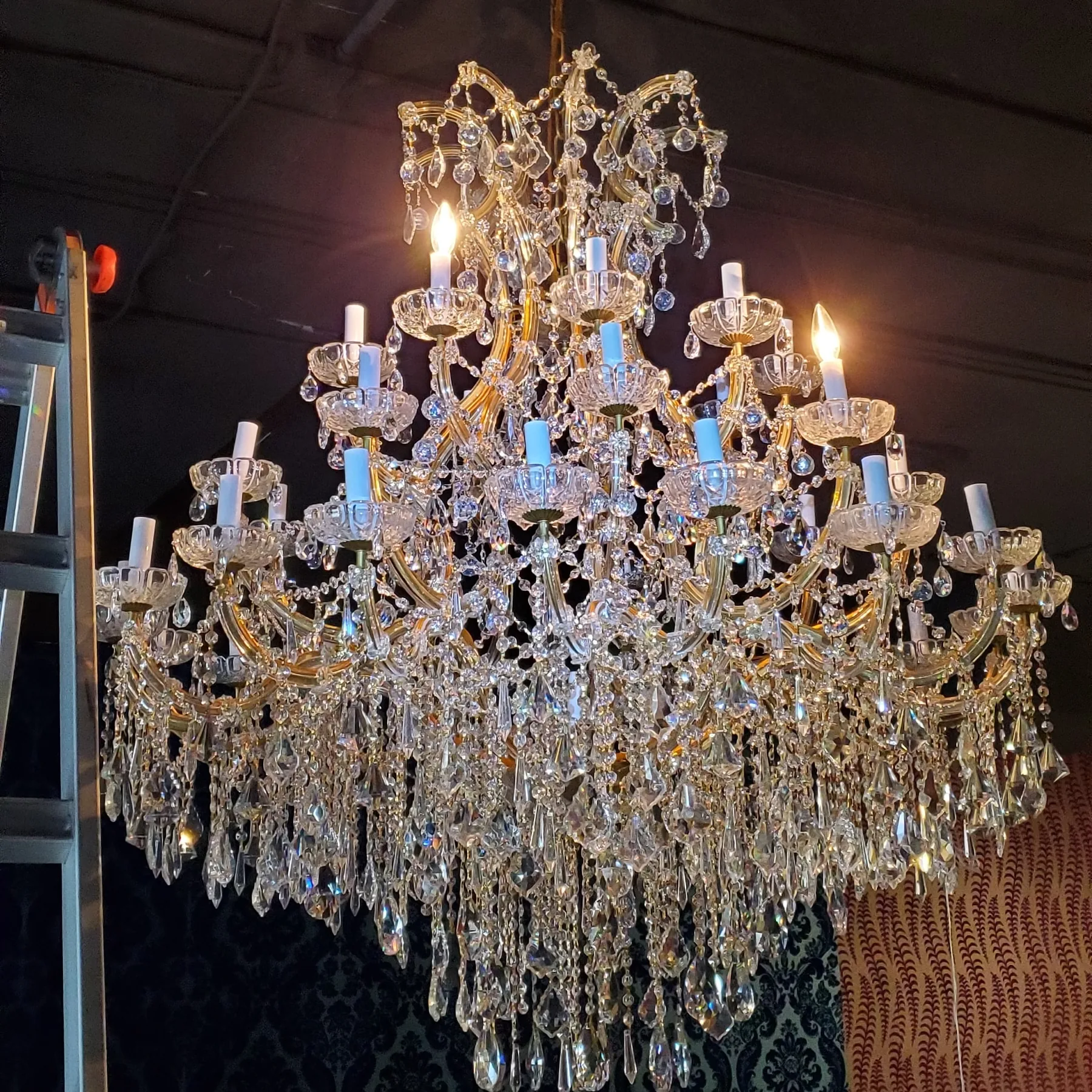 Traditional crystal chandelier installation in dining room